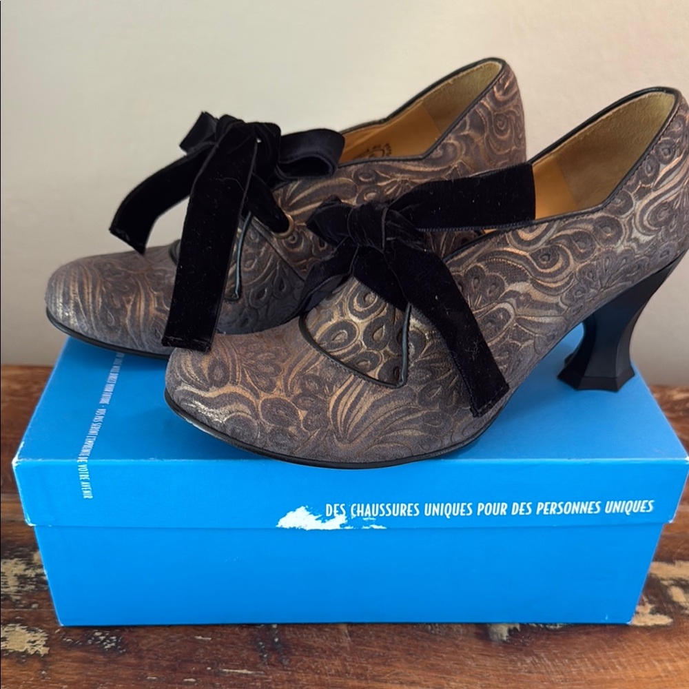John Fluevog Elisa-Betta Scallop Edge Heel. Brown Patterned Heels with Black Bow